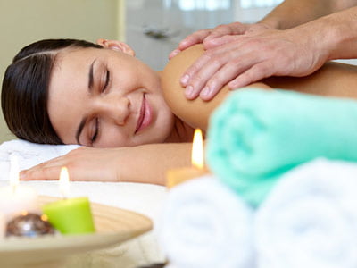 Woman enjoying a massage in a spa.